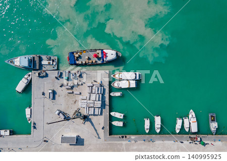 Aerial view of tour boats and logistic boats parking in the jetty at Maafushi island, Maldives Aerial view of tour boats and logistic boats parking in the jetty at Maafushi island, Maldives 140995925