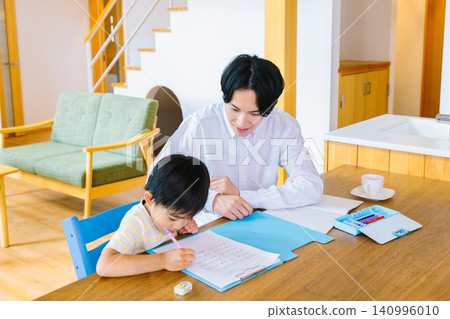 A father tutoring his elementary school-aged son. A father tutoring his elementary school-aged son. 140996010