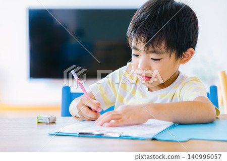 A young boy studying at home A young boy studying at home 140996057