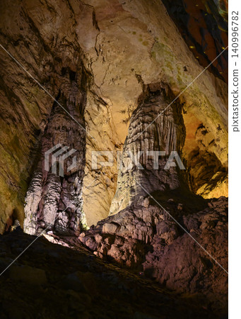 Stalactites and stalagmites colored by light in the huge Yellow Dragon Cave near Zhangjiajie, China Stalactites and stalagmites colored by light in the huge Yellow Dragon Cave near Zhangjiajie, China 140996782