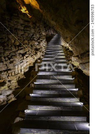 Stone staircase in the famous huge Yellow Dragon Cave in the mountains near Zhangjiajie, China Stone staircase in the famous huge Yellow Dragon Cave in the mountains near Zhangjiajie, China 140996783