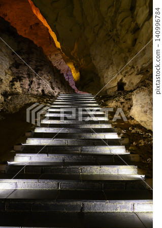 Stone staircase in the famous huge Yellow Dragon Cave in the mountains near Zhangjiajie, China 140996784