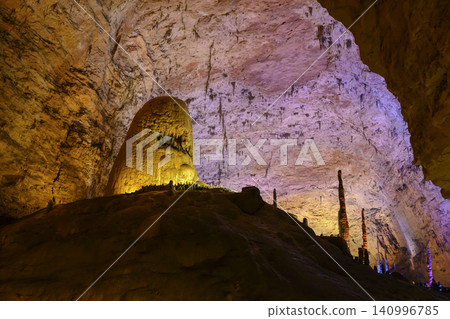 Stalactites and stalagmites colored by light in the huge Yellow Dragon Cave near Zhangjiajie, China Stalactites and stalagmites colored by light in the huge Yellow Dragon Cave near Zhangjiajie, China 140996785