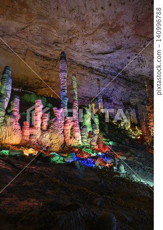 Stalactites and stalagmites colored by light in the huge Yellow Dragon Cave near Zhangjiajie, China Stalactites and stalagmites colored by light in the huge Yellow Dragon Cave near Zhangjiajie, China 140996788