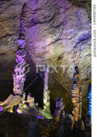 Stalactites and stalagmites colored by light in the huge Yellow Dragon Cave near Zhangjiajie, China Stalactites and stalagmites colored by light in the huge Yellow Dragon Cave near Zhangjiajie, China 140996789