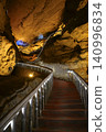 Winding stone staircase in a huge Yellow Dragon Cave in the mountains near Zhangjiajie, China 140996834