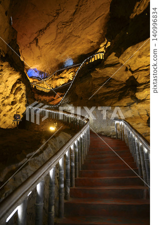 Winding stone staircase in a huge Yellow Dragon Cave in the mountains near Zhangjiajie, China Winding stone staircase in a huge Yellow Dragon Cave in the mountains near Zhangjiajie, China 140996834