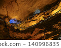 Winding stone staircase in a huge Yellow Dragon Cave in the mountains near Zhangjiajie, China 140996835