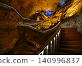 Winding stone staircase in a huge Yellow Dragon Cave in the mountains near Zhangjiajie, China 140996837