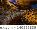Winding stone staircase in a huge Yellow Dragon Cave in the mountains near Zhangjiajie, China 140996839
