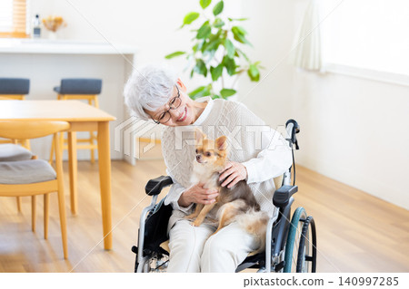 Elderly care: Senior woman relaxing with her pet dog. Elderly care: Senior woman relaxing with her pet dog. 140997285