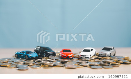 Multiple toy cars on scattered coins, representing car market pricing, vehicle finance comparison, fleet insurance, auto loan options, transportation cost, and purchase decision. Multiple toy cars on scattered coins, representing car market pricing, vehicle finance comparison, fleet insurance, auto loan options, transportation cost, and purchase decision. 140997521