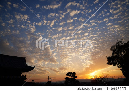 The cityscape of Kyoto bathed in the setting sun and the twilight at Kurotani Konkai Komyoji Temple. The cityscape of Kyoto bathed in the setting sun and the twilight at Kurotani Konkai Komyoji Temple. 140998355