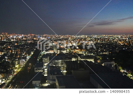 Osaka, Suita: Night view from a high-rise building, showing the JR Kyoto Line, Suita City Hall, and Osaka Port (southwest direction from Merode Suita, early summer). 140998435
