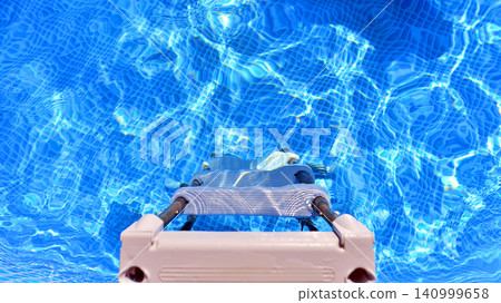 Outdoor swimming pool with clean water and ladder, above view 140999658