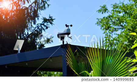 Weather station sensor installed on a pergola rooftop against a clear blue sky Weather station sensor installed on a pergola rooftop against a clear blue sky 140999693