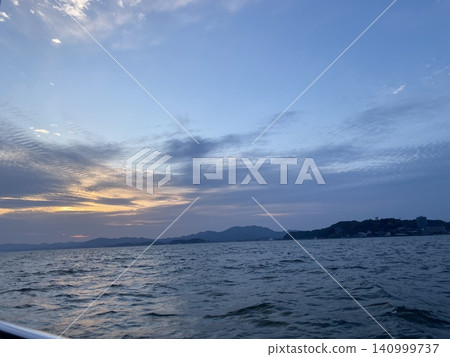 A moment on Lake Shinji where the evening sky is reflected on the calm surface. A moment on Lake Shinji where the evening sky is reflected on the calm surface. 140999737