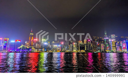 The beautiful night view of Hong Kong's skyscrapers, with light reflecting on the surface of Victoria Harbour. The beautiful night view of Hong Kong's skyscrapers, with light reflecting on the surface of Victoria Harbour. 140999991