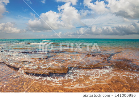 Rocky coast in summer. Beautiful seascape. Sunset beach Rocky coast in summer. Beautiful seascape. Sunset beach 141000986
