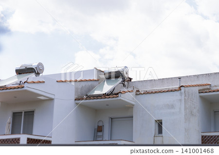 Solar water heaters on white mediterranean building roofs Solar water heaters on white mediterranean building roofs 141001468