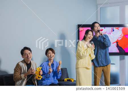 A man and a woman singing karaoke A man and a woman singing karaoke 141001509