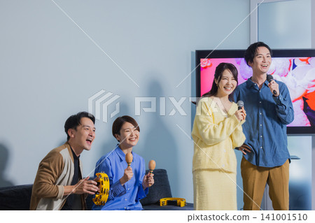 A man and a woman singing karaoke A man and a woman singing karaoke 141001510