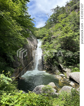 Senga Falls in Shosenkyo Gorge, surrounded by fresh greenery. Senga Falls in Shosenkyo Gorge, surrounded by fresh greenery. 141001587