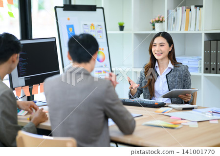 Asian UI UX Designer and Developer Team Brainstorming App Design in Modern Office Meeting Asian UI UX Designer and Developer Team Brainstorming App Design in Modern Office Meeting 141001770