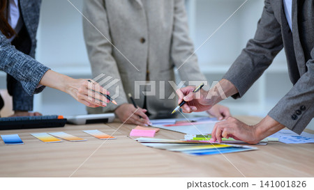 Creative Design Team Reviewing Color Swatches and Samples During Collaborative Brainstorming Meeting Creative Design Team Reviewing Color Swatches and Samples During Collaborative Brainstorming Meeting 141001826