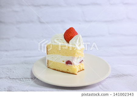 Cross-section and side view of a partially eaten strawberry shortcake. Cross-section and side view of a partially eaten strawberry shortcake. 141002343