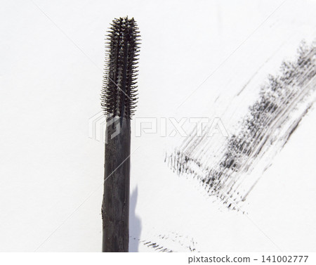 Close-up of a brush of black ink, smears and doodles isolated on a white background Close-up of a brush of black ink, smears and doodles isolated on a white background 141002777