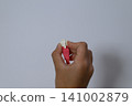 Hand holding the LAN cable plug 141002879
