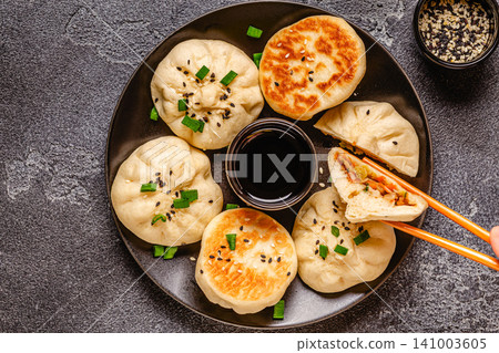 Delicious buns served on a plate with sauces and toppings 141003605