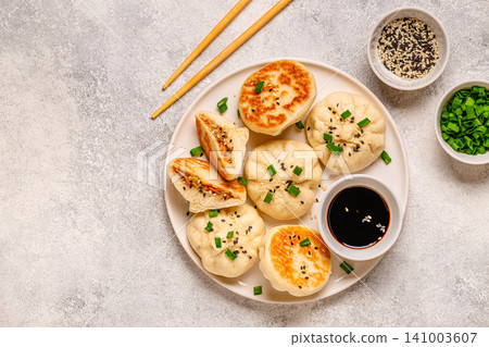 Delicious buns served on a plate with sauces and toppings 141003607