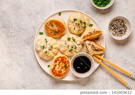 Delicious buns served on a plate with sauces and toppings Delicious buns served on a plate with sauces and toppings 141003612