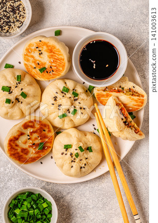 Delicious buns served on a plate with sauces and toppings Delicious buns served on a plate with sauces and toppings 141003613