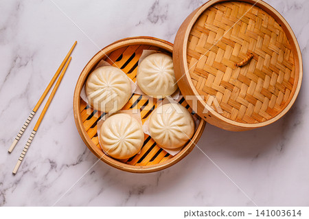 Steamed buns in bamboo steamer on a kitchen counter Steamed buns in bamboo steamer on a kitchen counter 141003614