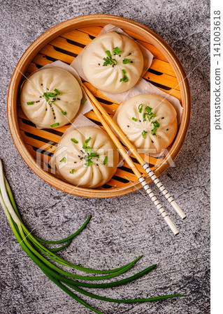 Steamed buns in bamboo steamer on a kitchen counter Steamed buns in bamboo steamer on a kitchen counter 141003618