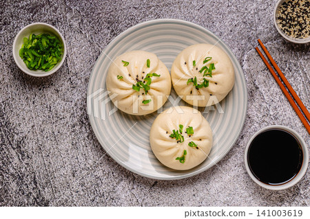 Dumplings on a plate with chopsticks and soy sauce 141003619