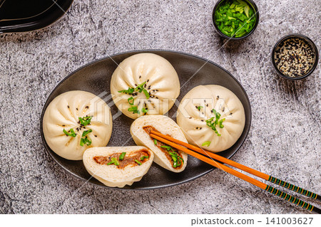 Steamed buns on a dark plate. Steamed buns on a dark plate. 141003627