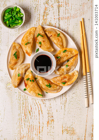 Dumplings served on a plate with soy sauce Dumplings served on a plate with soy sauce 141003714
