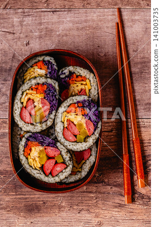 Colorful kimbap (or gimbap) with vegetables and sausage in a wooden box Colorful kimbap (or gimbap) with vegetables and sausage in a wooden box 141003735