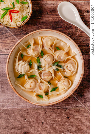 Warm bowl of wonton soup served with green onions. Warm bowl of wonton soup served with green onions. 141003804