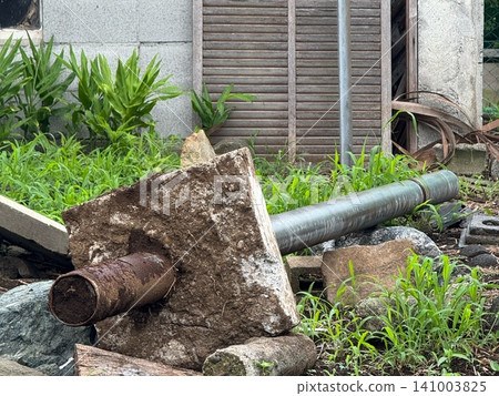 The remains of old, collapsed concrete pillars and iron pipes. The remains of old, collapsed concrete pillars and iron pipes. 141003825