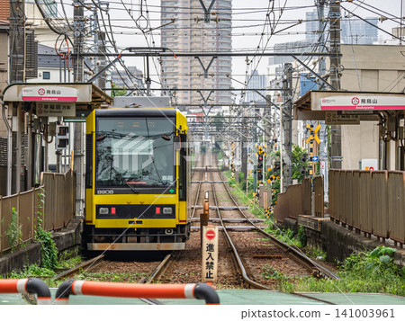 A streetcar and dedicated track stopping at Asukayama Station on the Toden Arakawa Line. A streetcar and dedicated track stopping at Asukayama Station on the Toden Arakawa Line. 141003961