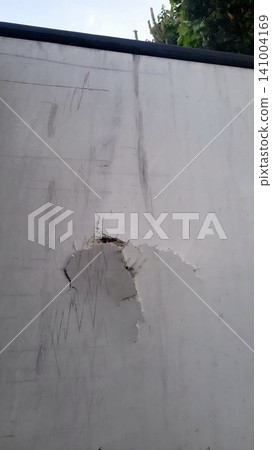 Dent and puncture damage on a white refrigerator truck door, vehicle maintenance issue, transport safety. Dent and puncture damage on a white refrigerator truck door, vehicle maintenance issue, transport safety. 141004169