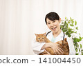 A female doctor holding a tabby cat 141004450