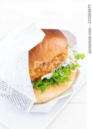A delicious katsu burger wrapped in paper A delicious katsu burger wrapped in paper 141004675