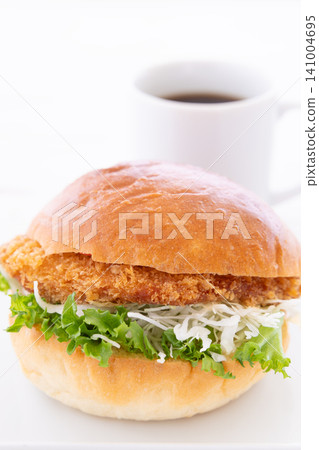 A delicious katsu burger and coffee for breakfast. A delicious katsu burger and coffee for breakfast. 141004695