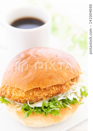 A delicious katsu burger and coffee for breakfast. A delicious katsu burger and coffee for breakfast. 141004698
